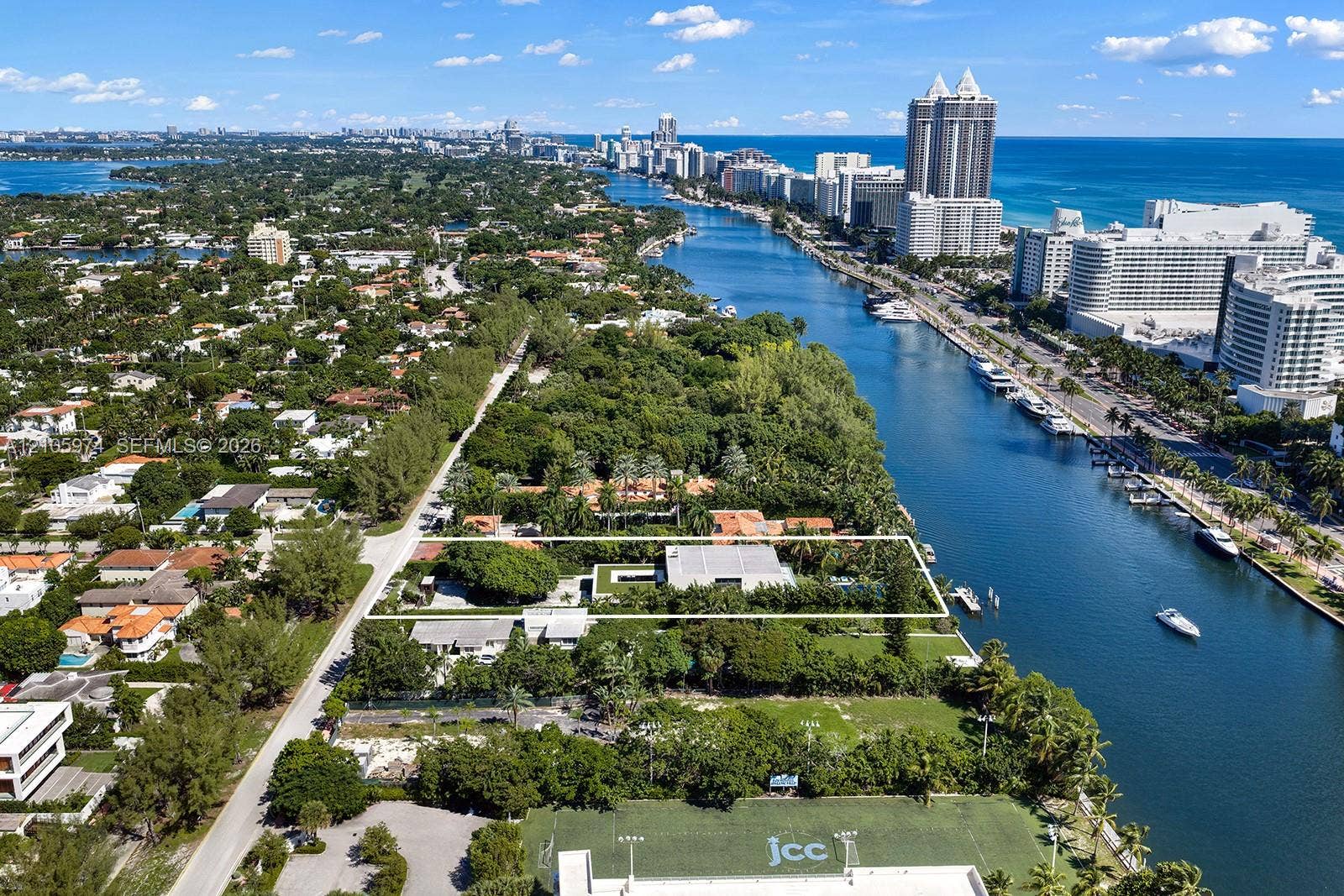 4395 Pine Tree Drive, Miami Beach, FL 33140 Waterfront property featuring deep-water access, a private dock, and an expansive lawn