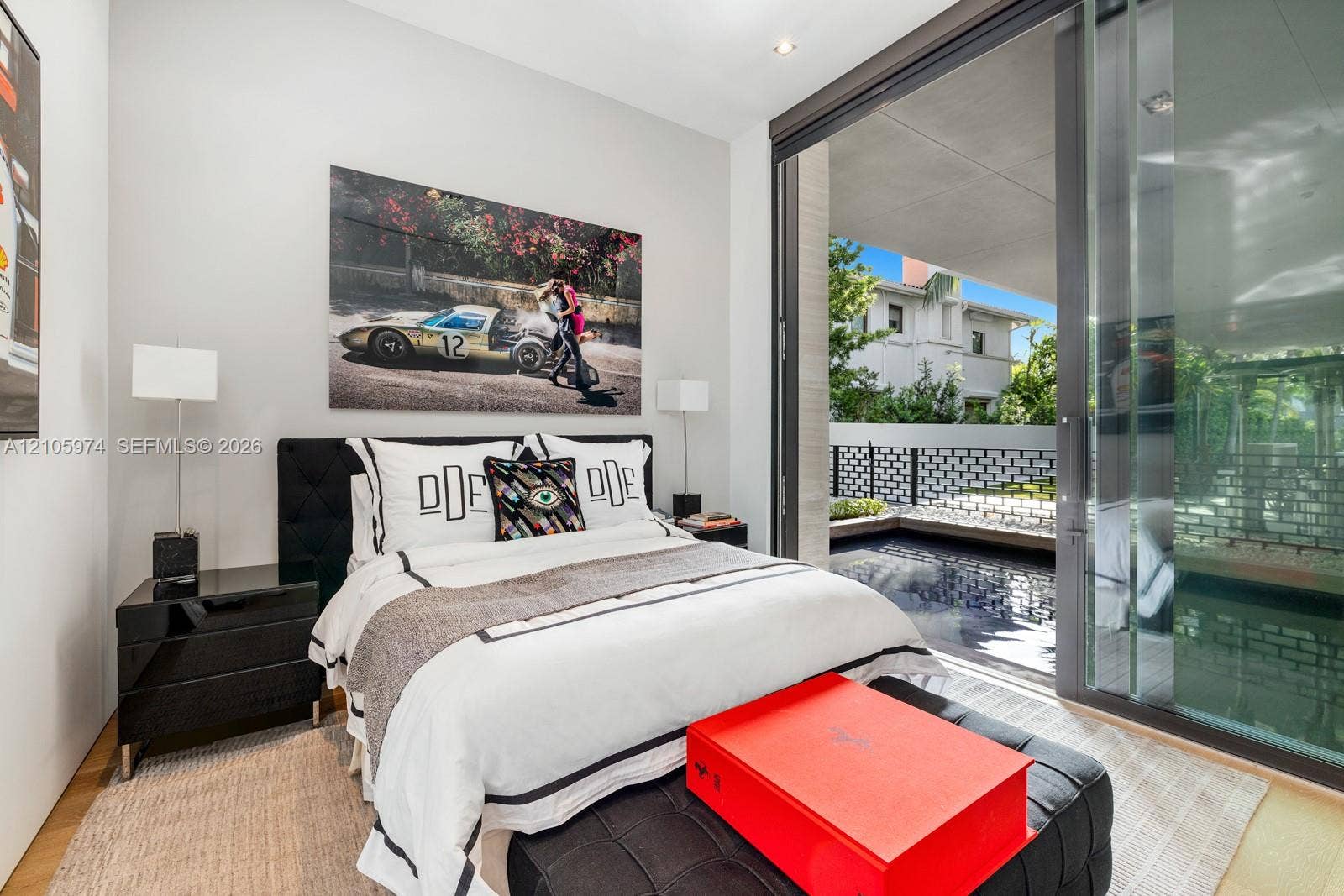 4395 Pine Tree Drive, Miami Beach, FL 33140 Floor-to-ceiling sliding glass panels, recessed ceiling lighting, and wood-finish flooring