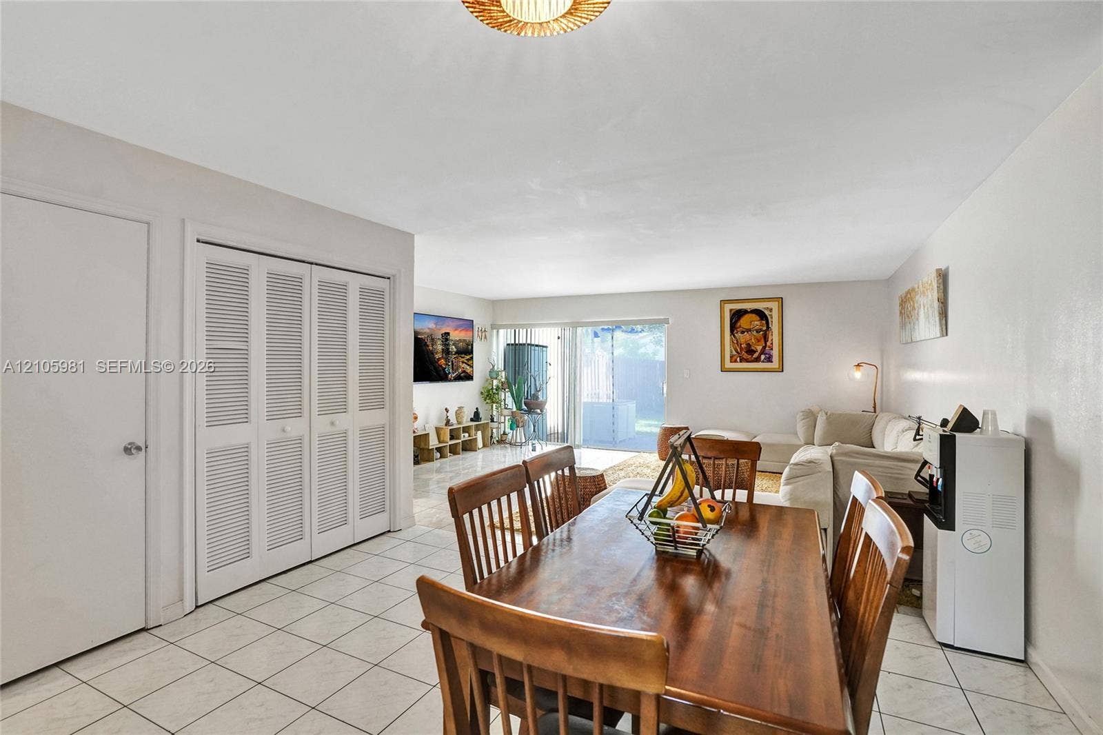 6813 NW 29th Avenue, Fort Lauderdale, Fort Lauderdale, FL 33309 Ceramic tile flooring, louvered bi-fold closet doors, and sliding glass patio door