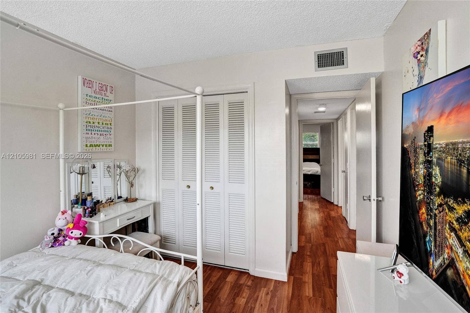 6813 NW 29th Avenue, Fort Lauderdale, Fort Lauderdale, FL 33309 Wood-finish flooring, white louvered-panel closet doors, and smooth-finish ceilings