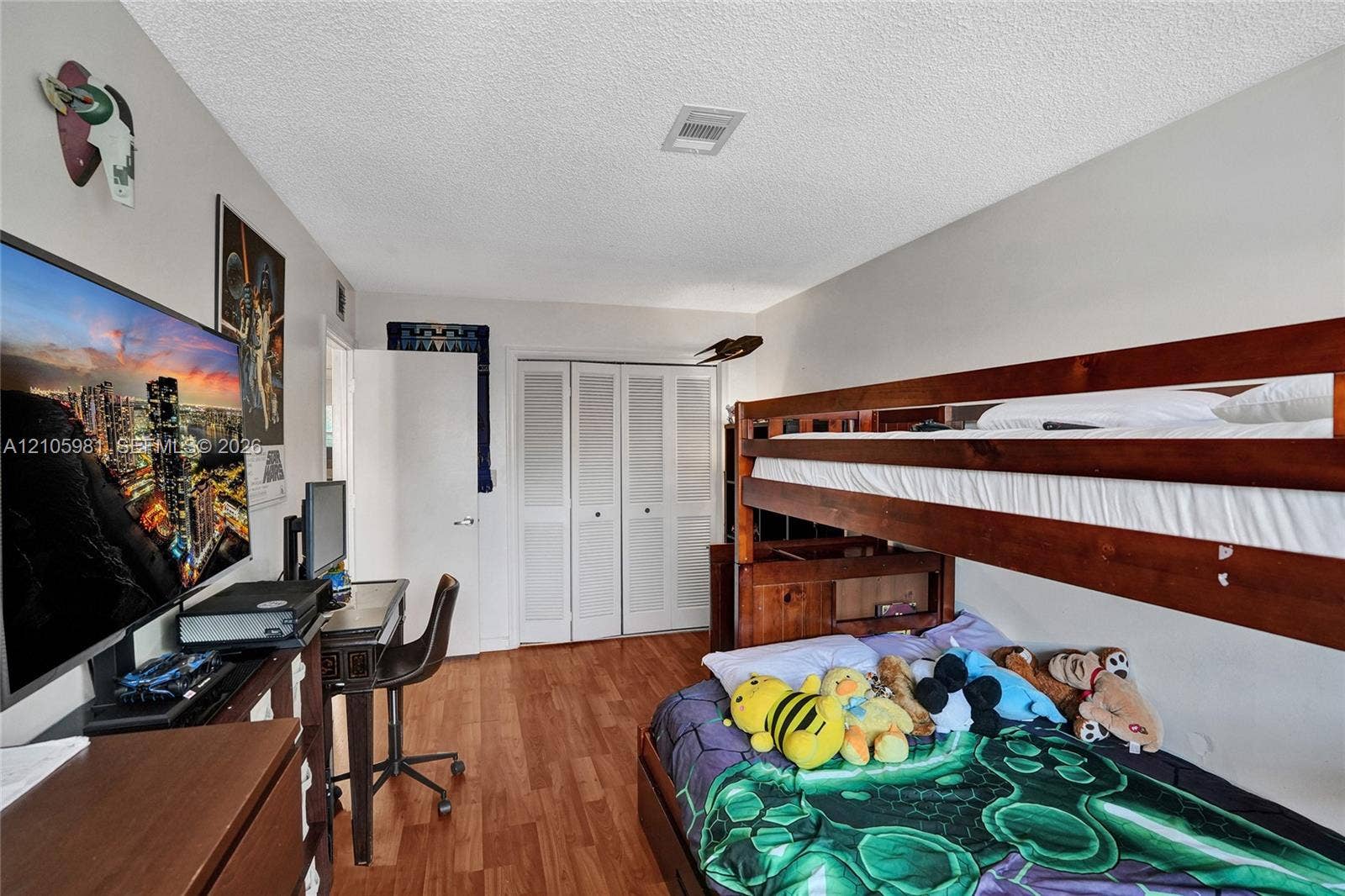 6813 NW 29th Avenue, Fort Lauderdale, Fort Lauderdale, FL 33309 Room featuring wood-finish flooring and a closet with bifold louvered doors