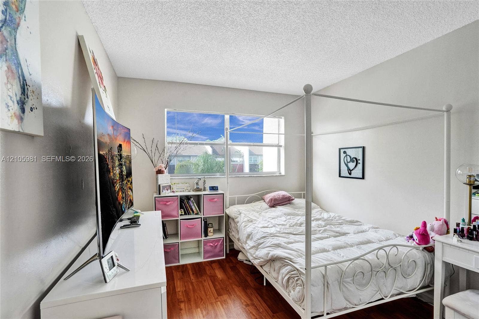 6813 NW 29th Avenue, Fort Lauderdale, Fort Lauderdale, FL 33309 Wood-finish flooring, neutral wall tones, and a large horizontal window providing natural light