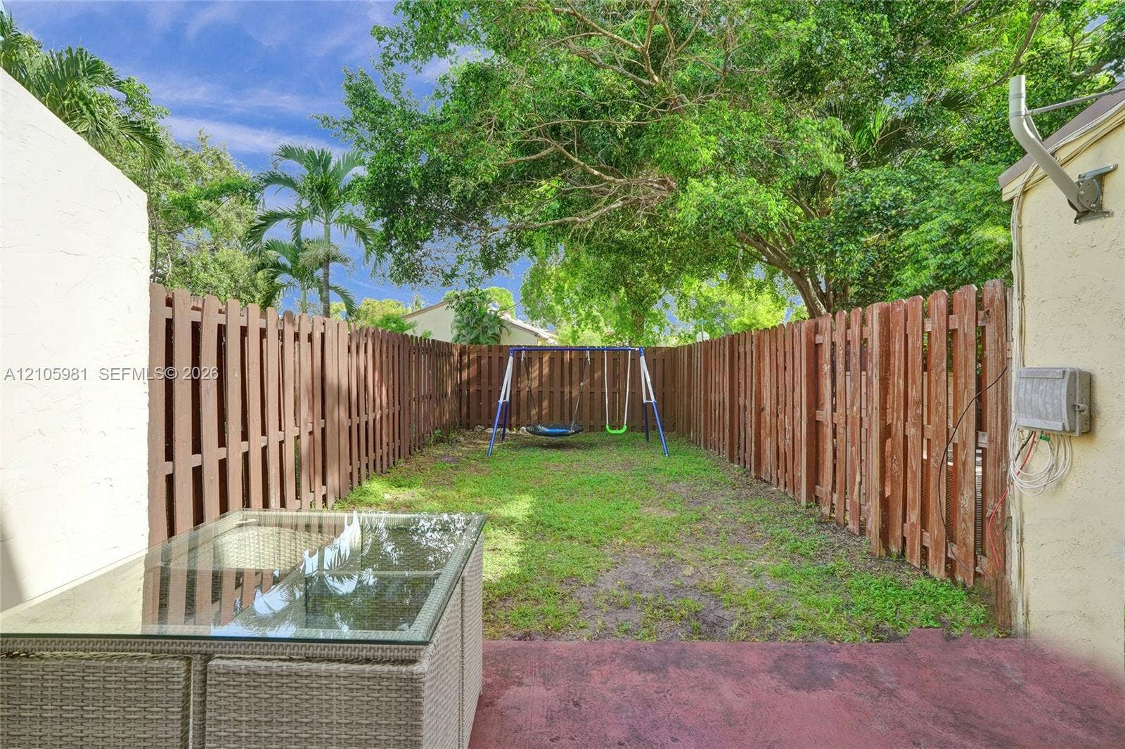6813 NW 29th Avenue, Fort Lauderdale, Fort Lauderdale, FL 33309 Fenced-in backyard featuring a grass lawn and mature trees