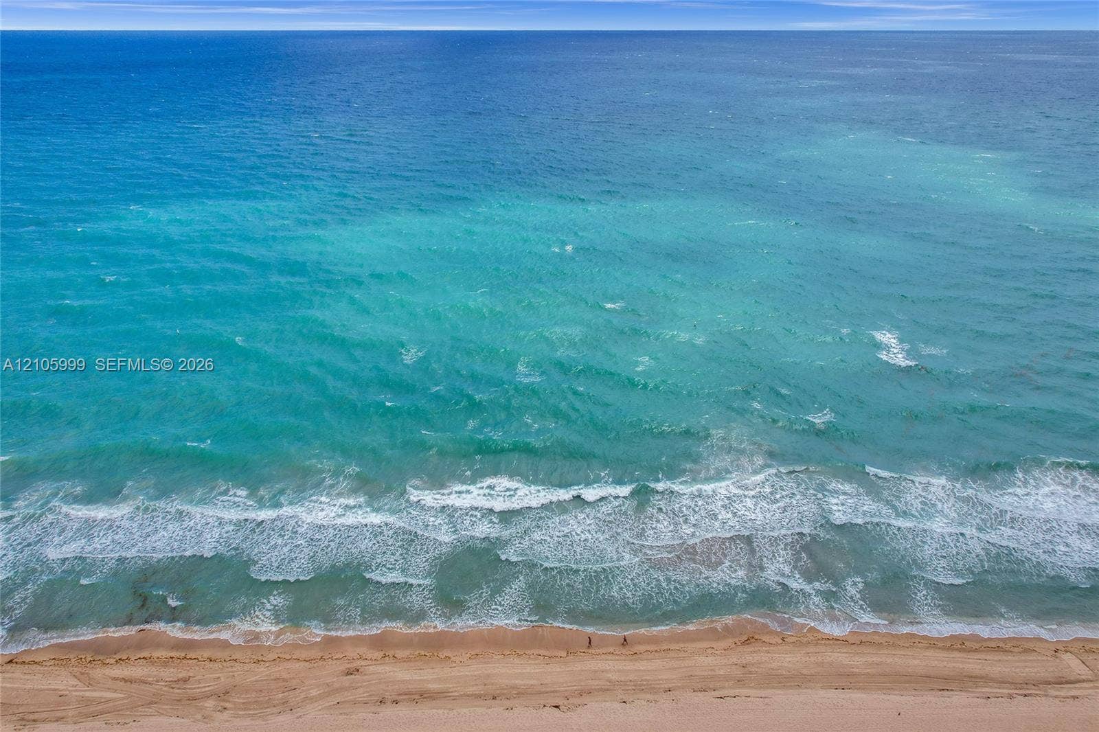 Direct oceanfront access with expansive sandy beach frontage and unobstructed water scenery