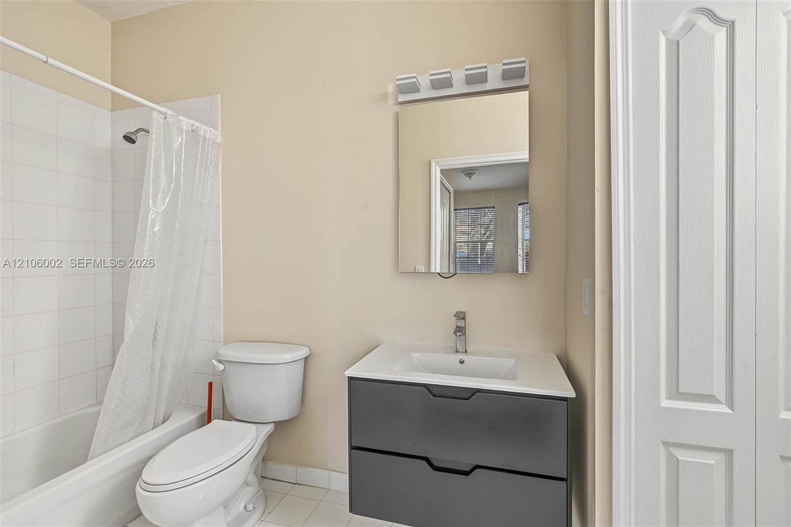 Modern vanity featuring a charcoal-finished dual-drawer cabinet, white countertop with integrated sink, and polished chrome faucet