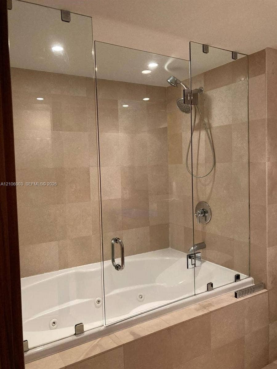 1850 S Ocean Drive, #3309, Hallandale Beach, Hallandale Beach, FL 33009 Jetted soaking tub with tile surround, frameless glass panel, and adjustable handheld shower fixture