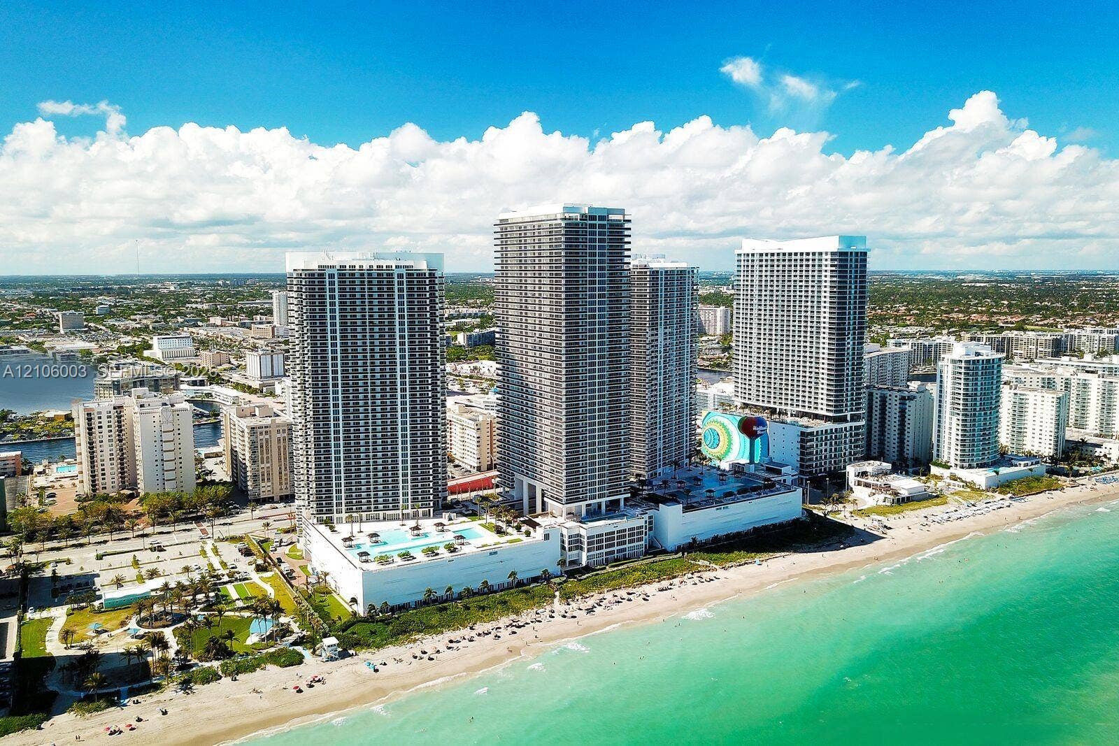 1850 S Ocean Drive, #3309, Hallandale Beach, Hallandale Beach, FL 33009 High-rise residential complex situated on the oceanfront featuring expansive exterior terraces, multi-level podium parking, and elevated outdoor swimming pools