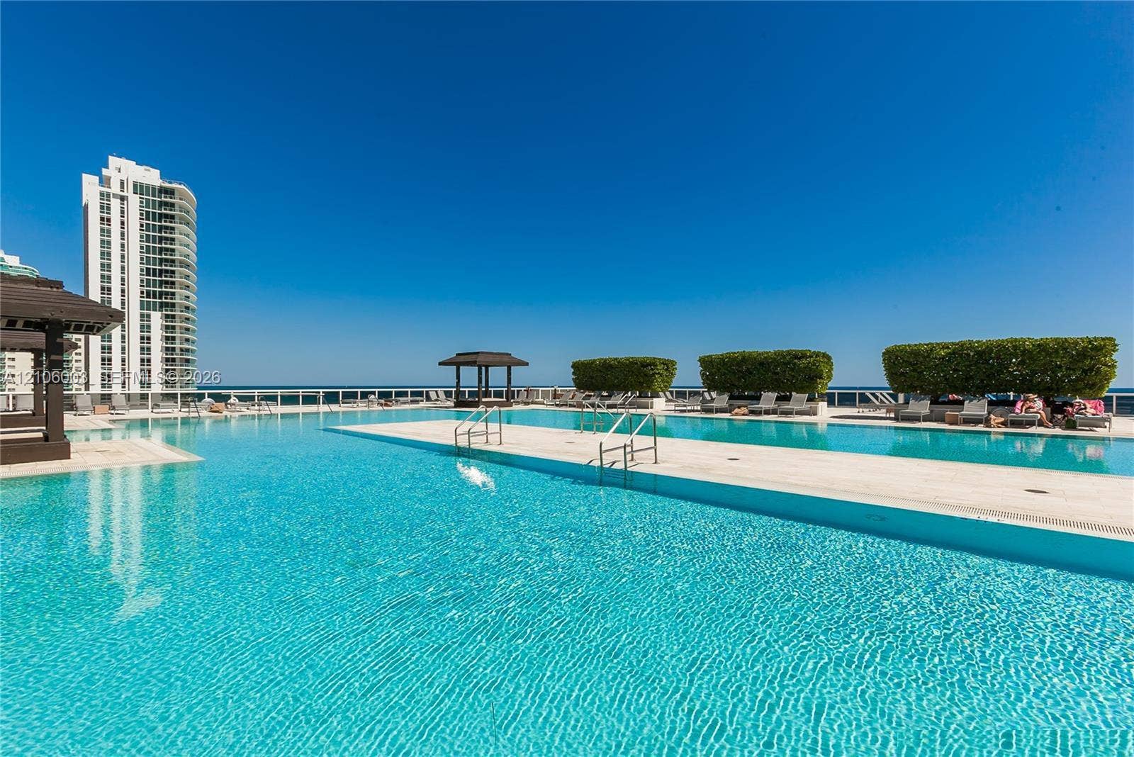1850 S Ocean Drive, #3309, Hallandale Beach, Hallandale Beach, FL 33009 Rooftop swimming pool with tiled decking, metal railings, and built-in shade structures