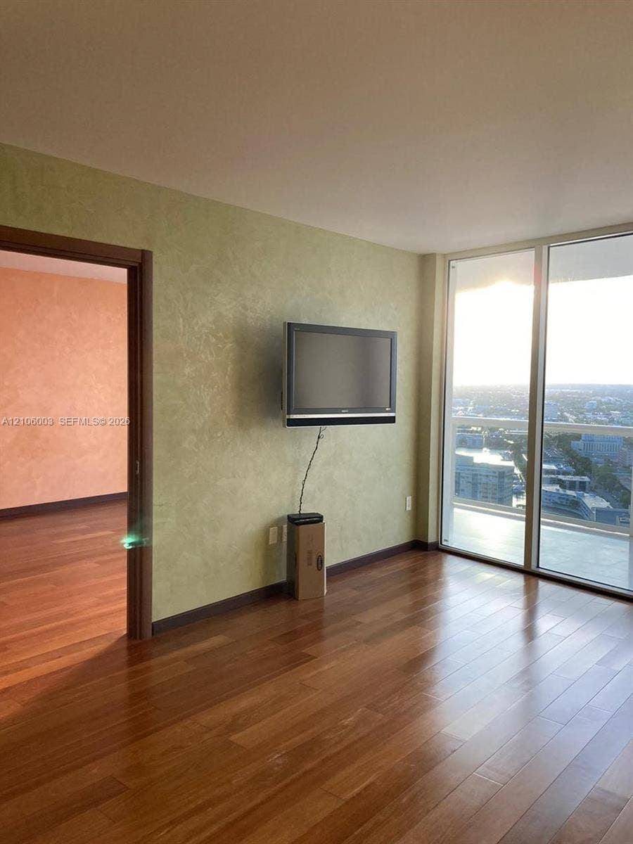 1850 S Ocean Drive, #3309, Hallandale Beach, Hallandale Beach, FL 33009 Floor-to-ceiling glass windows, wood-finish flooring, and textured wall finishes