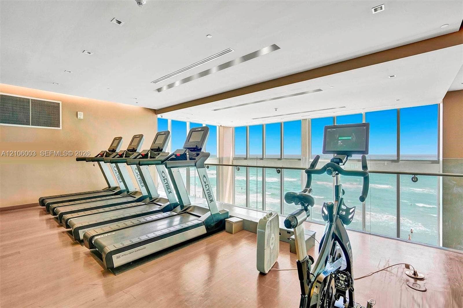 1850 S Ocean Drive, #3309, Hallandale Beach, Hallandale Beach, FL 33009 Fitness room featuring floor-to-ceiling windows, wood-finish flooring, recessed lighting, and a glass-paneled railing