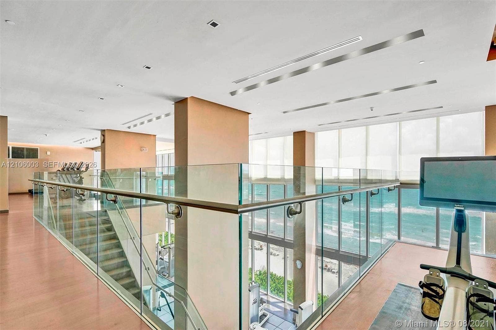 1850 S Ocean Drive, #3309, Hallandale Beach, Hallandale Beach, FL 33009 Multi-level space featuring floor-to-ceiling windows, ocean horizon, glass panel railings, recessed linear lighting, and wood-finish flooring