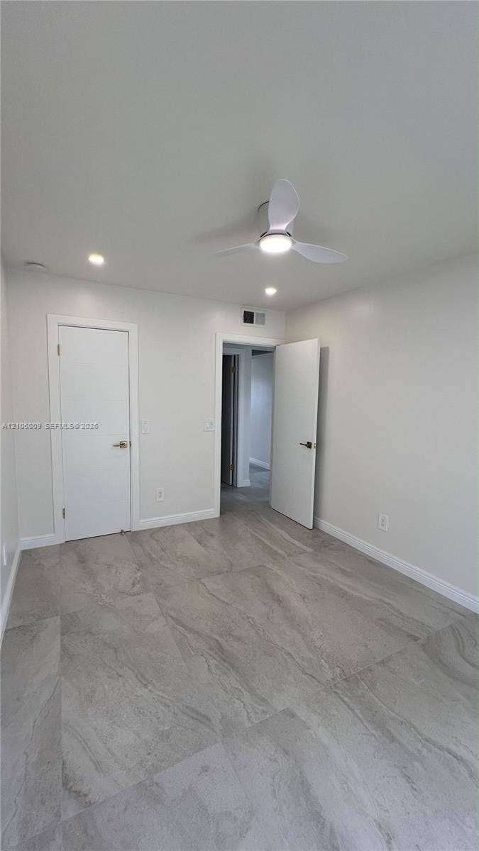 495 Fanshaw L, Boca Raton, FL 33434 Large-format tile flooring, modern three-blade ceiling fan with integrated lighting, and recessed ceiling lights