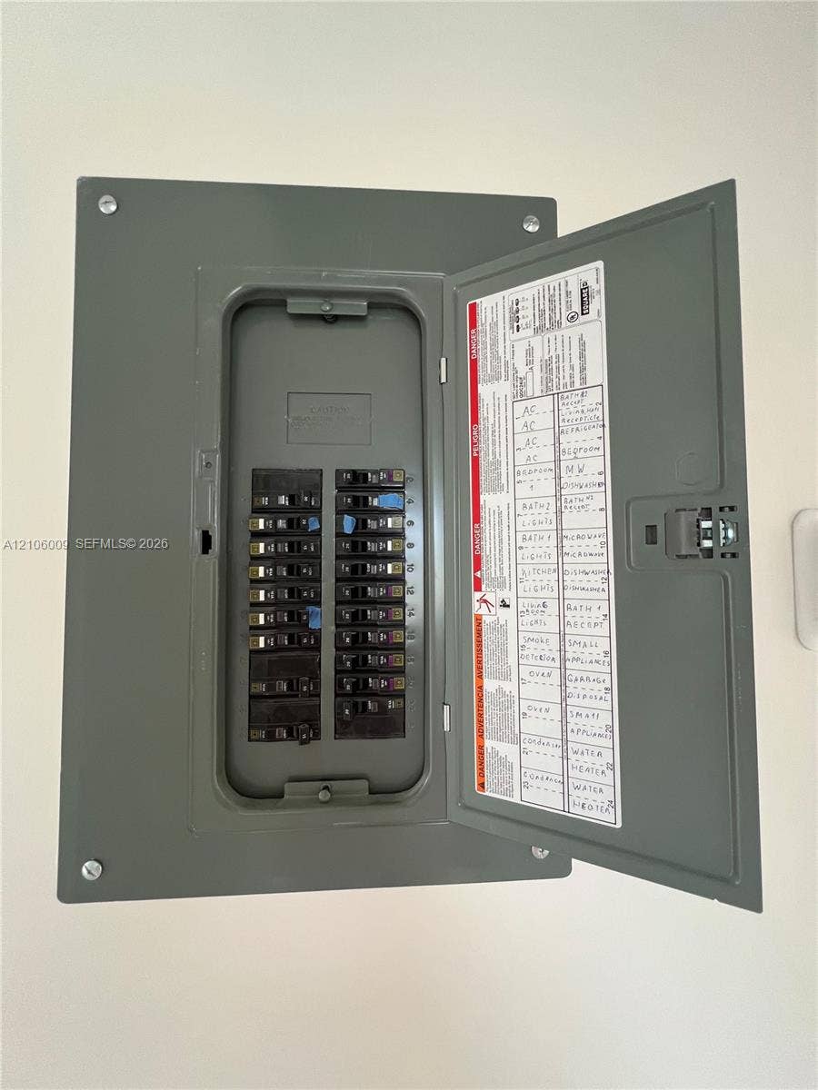 495 Fanshaw L, Boca Raton, FL 33434 Electrical service panel featuring a multi-circuit breaker configuration with a hinged metal door and clearly labeled directory