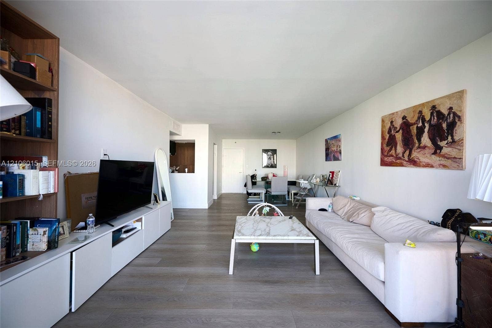 2851 NE 183rd Street, #1109E, Aventura, FL 33160 Open-concept living space featuring wood-finish flooring and extensive built-in white cabinetry