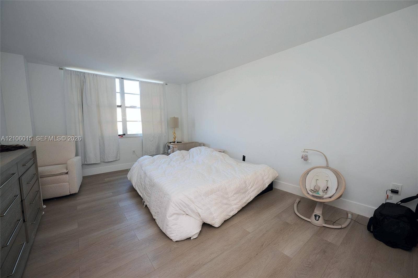 2851 NE 183rd Street, #1109E, Aventura, FL 33160 Neutral interior featuring wood-finish flooring, white walls, and a large multi-pane window