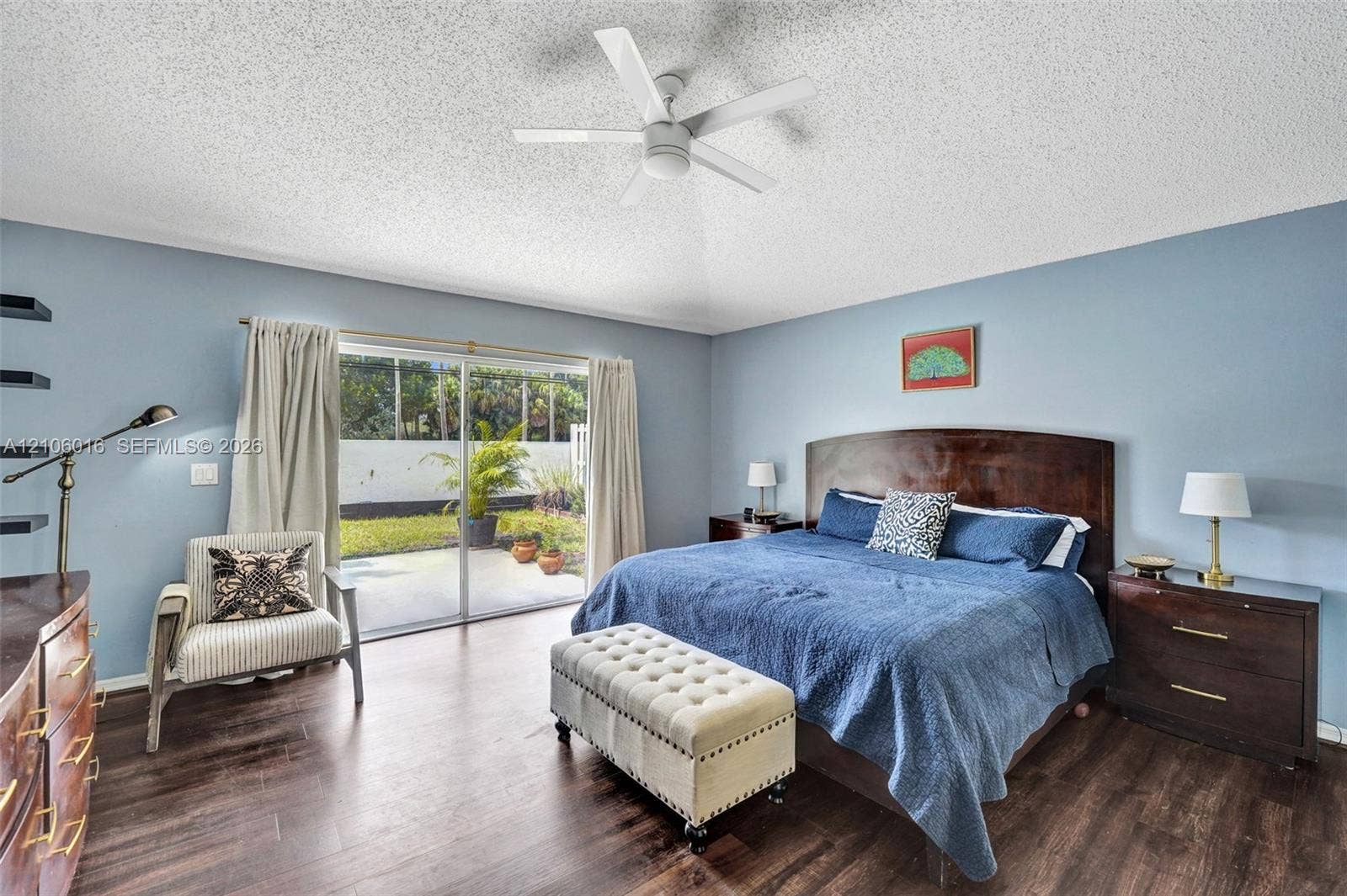 631 NW 135th Terrace, Plantation, FL 33325 Spacious room featuring wood-finish flooring, a ceiling fan, and sliding glass doors providing outdoor access