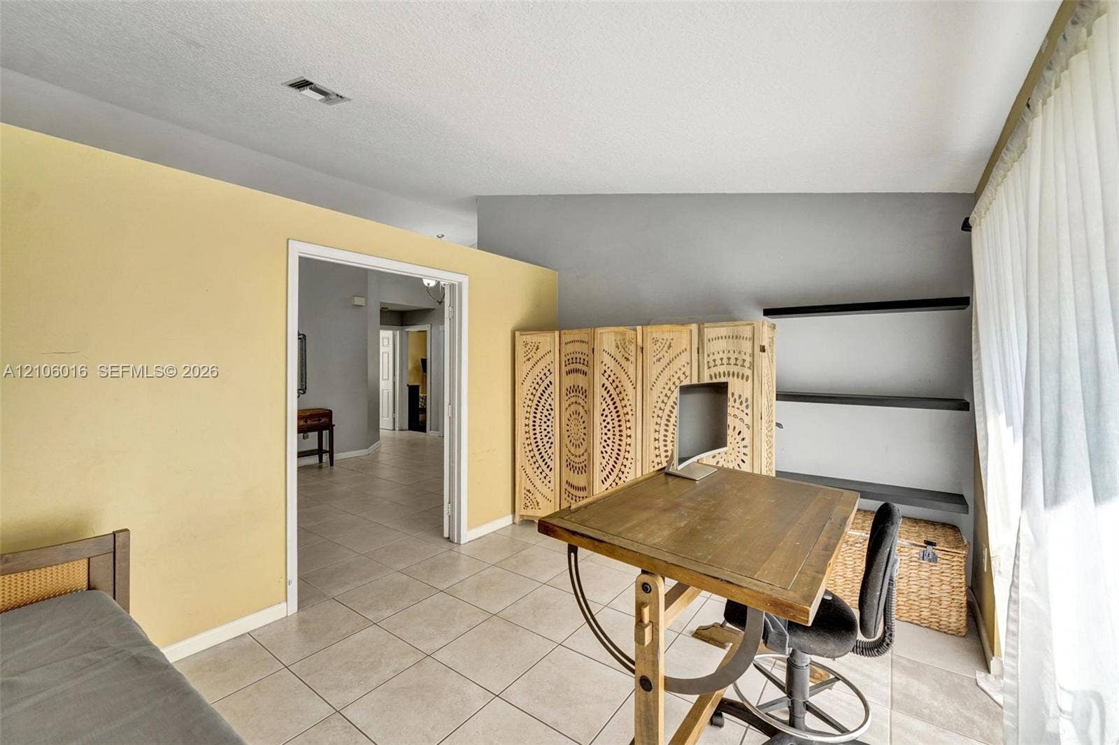 631 NW 135th Terrace, Plantation, FL 33325 Room featuring tile flooring, vaulted ceilings, and wall-mounted shelving