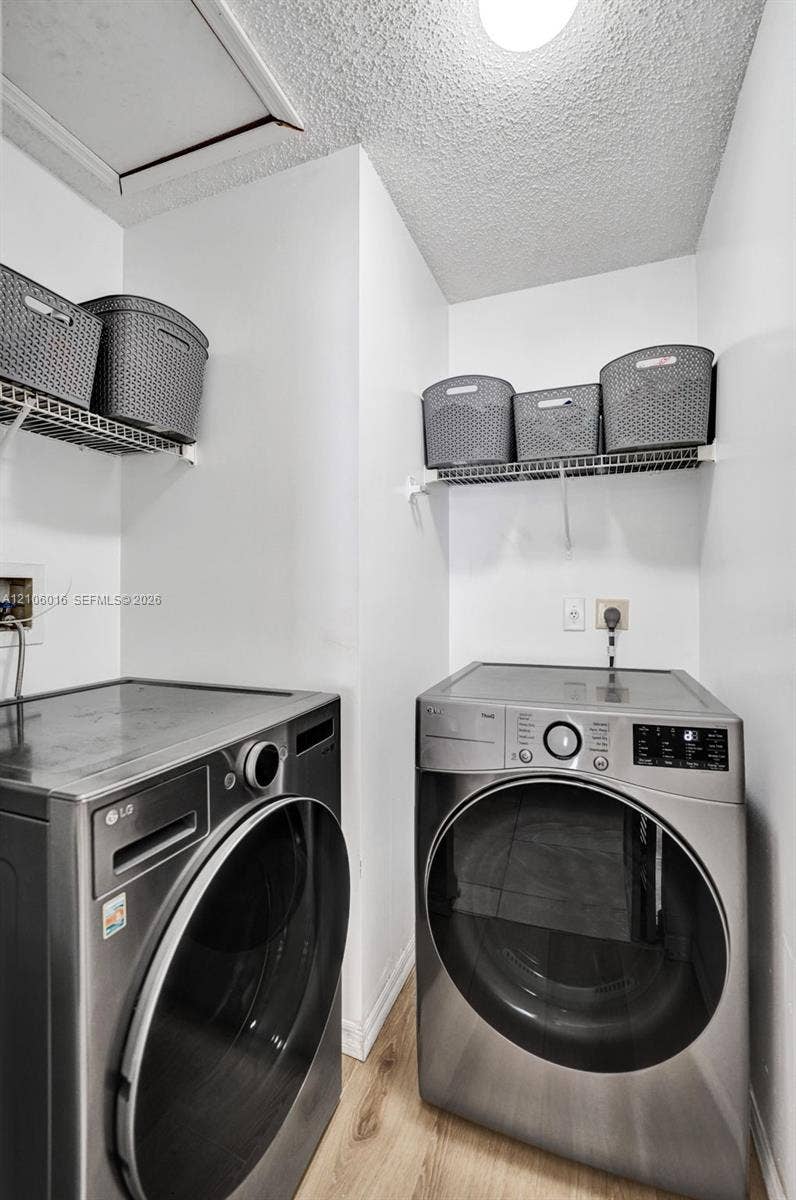 631 NW 135th Terrace, Plantation, FL 33325 Dedicated laundry area featuring wire shelving and wood-finish flooring
