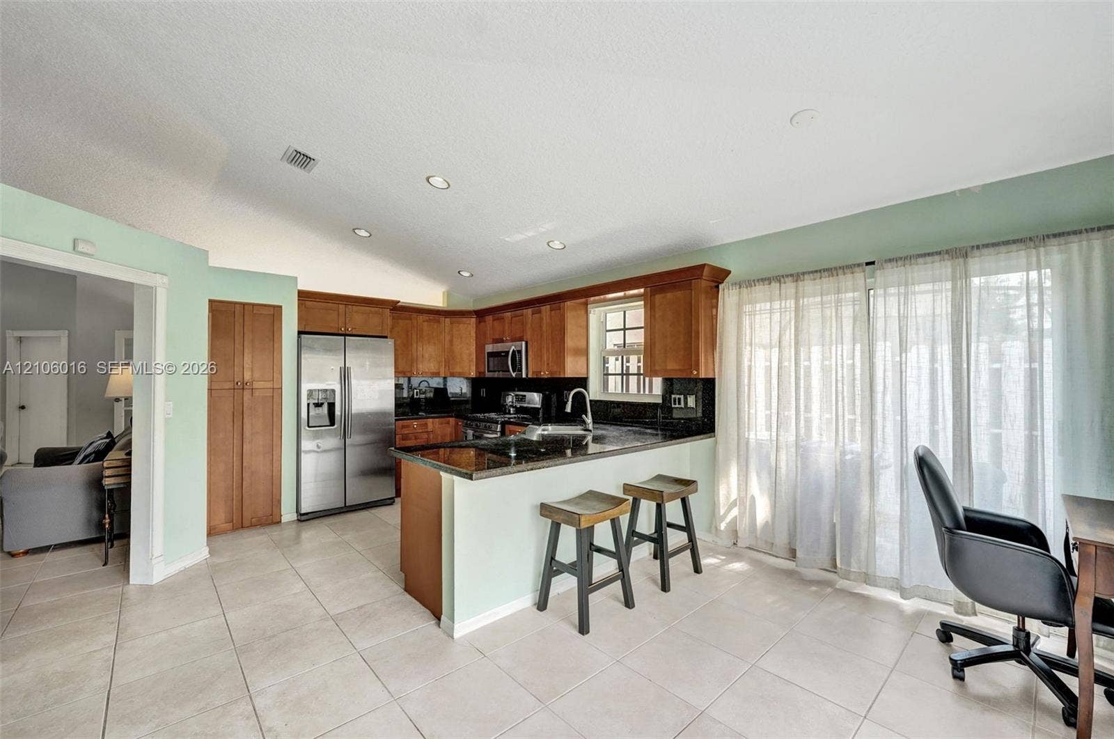 631 NW 135th Terrace, Plantation, FL 33325 Kitchen featuring wood cabinetry, stainless steel appliances, dark stone-finish countertops, ceramic tile flooring, and recessed lighting