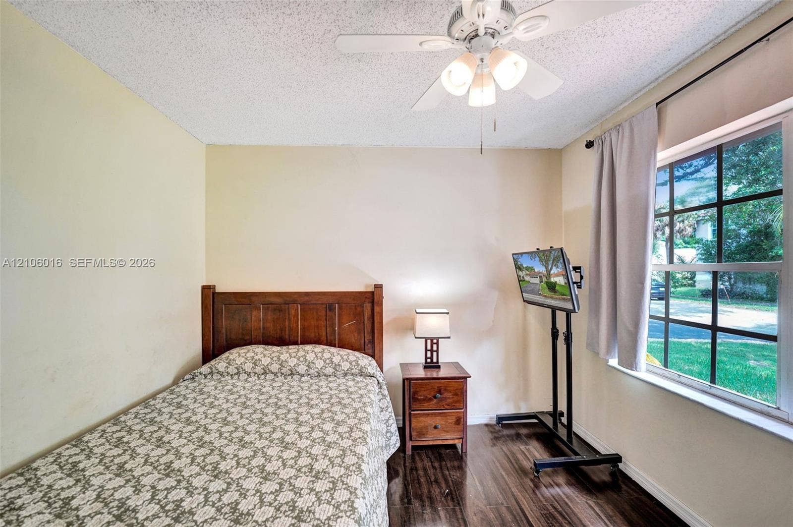 631 NW 135th Terrace, Plantation, FL 33325 Room featuring wood-finish flooring, a multi-light ceiling fan, and a grid-pane window