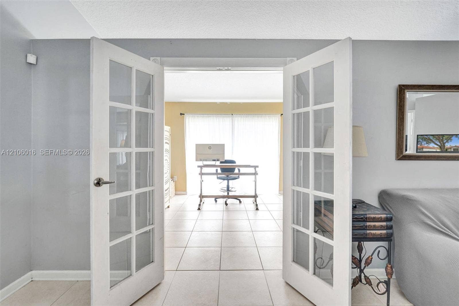 631 NW 135th Terrace, Plantation, FL 33325 White-framed French doors with glass panes and ceramic tile flooring