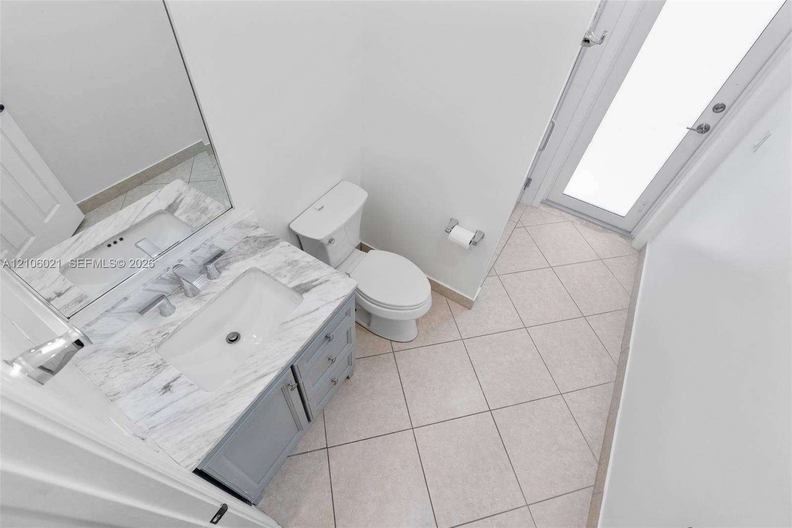 19510 S Coquina Way, Weston, FL 33332 Bathroom featuring a vanity with a stone-top surface, undermount sink, grey cabinetry, ceramic tile flooring, and a glass-paneled exterior door