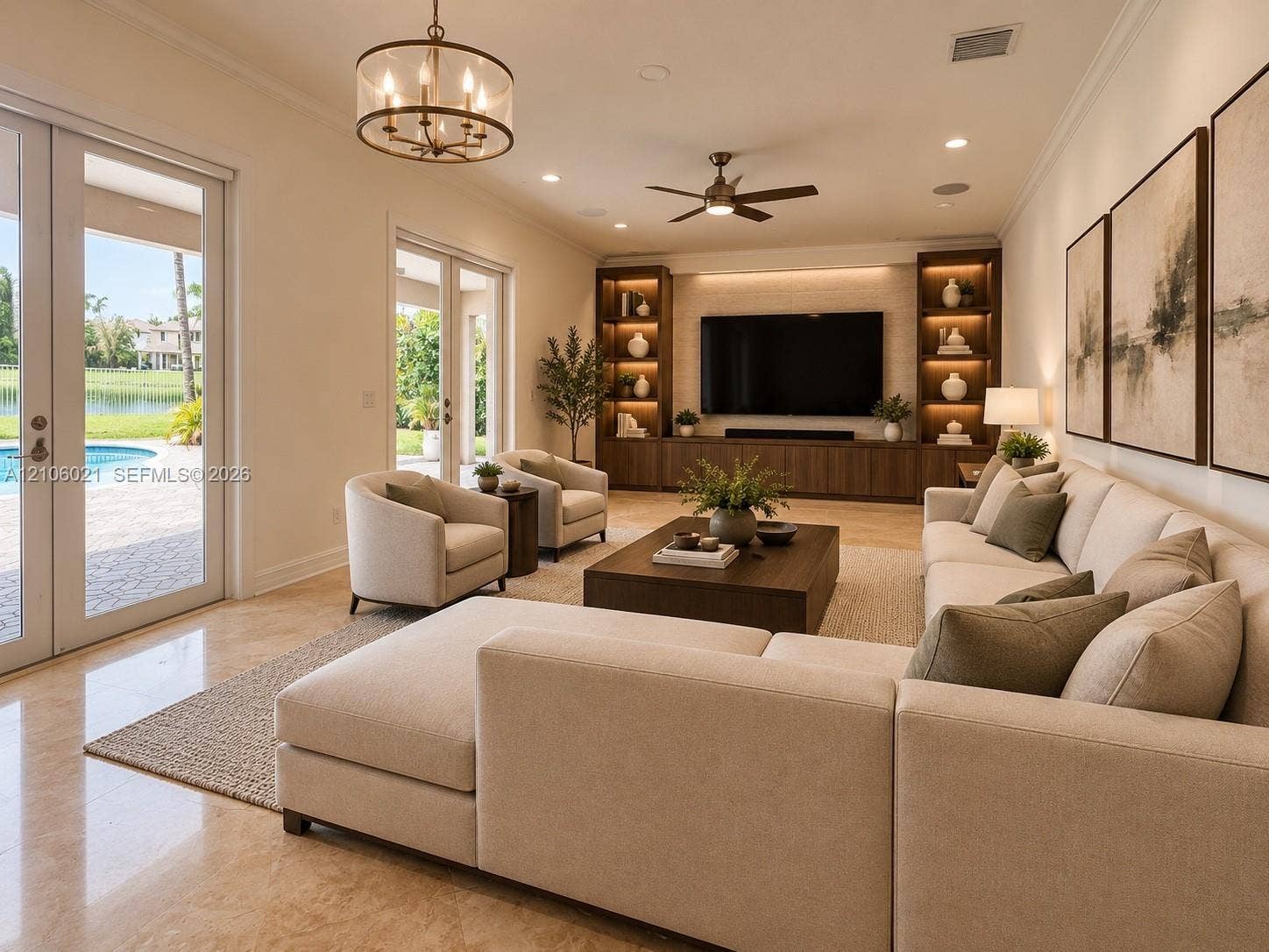 19510 S Coquina Way, Weston, FL 33332 Living room featuring polished stone flooring, custom built-in cabinetry with integrated accent lighting, a ceiling fan, crown molding, and dual French doors