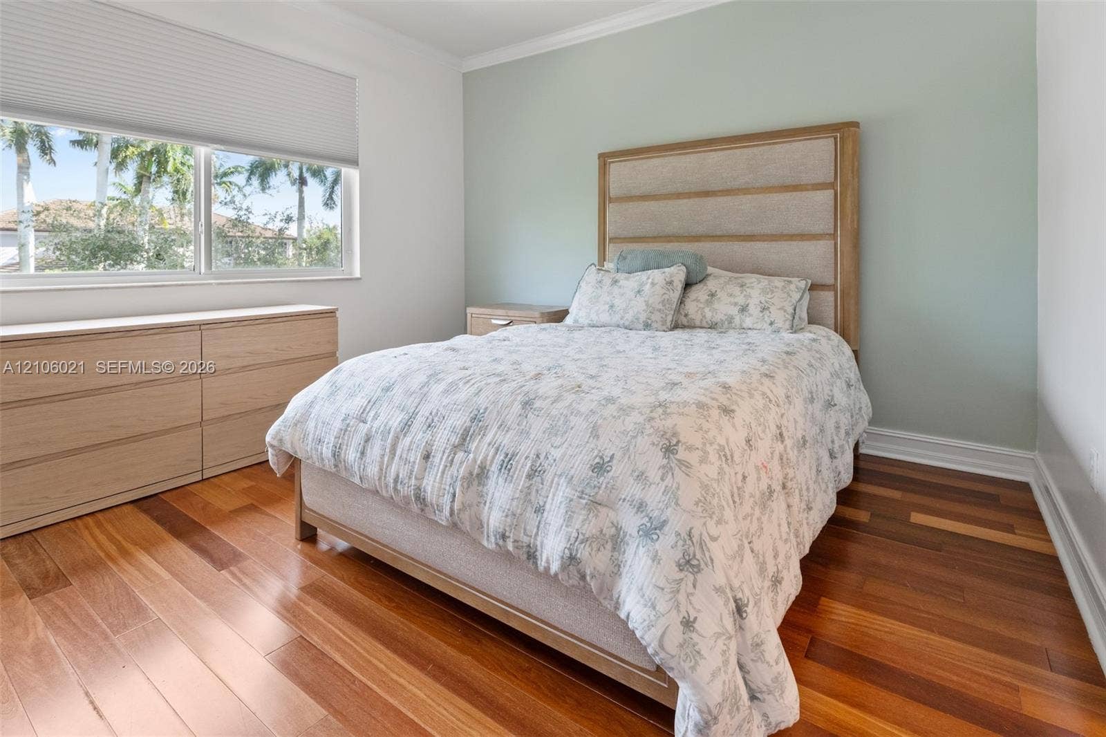 19510 S Coquina Way, Weston, FL 33332 Wood-finish flooring, light-toned built-in cabinetry, and a horizontal window featuring a retractable roller shade