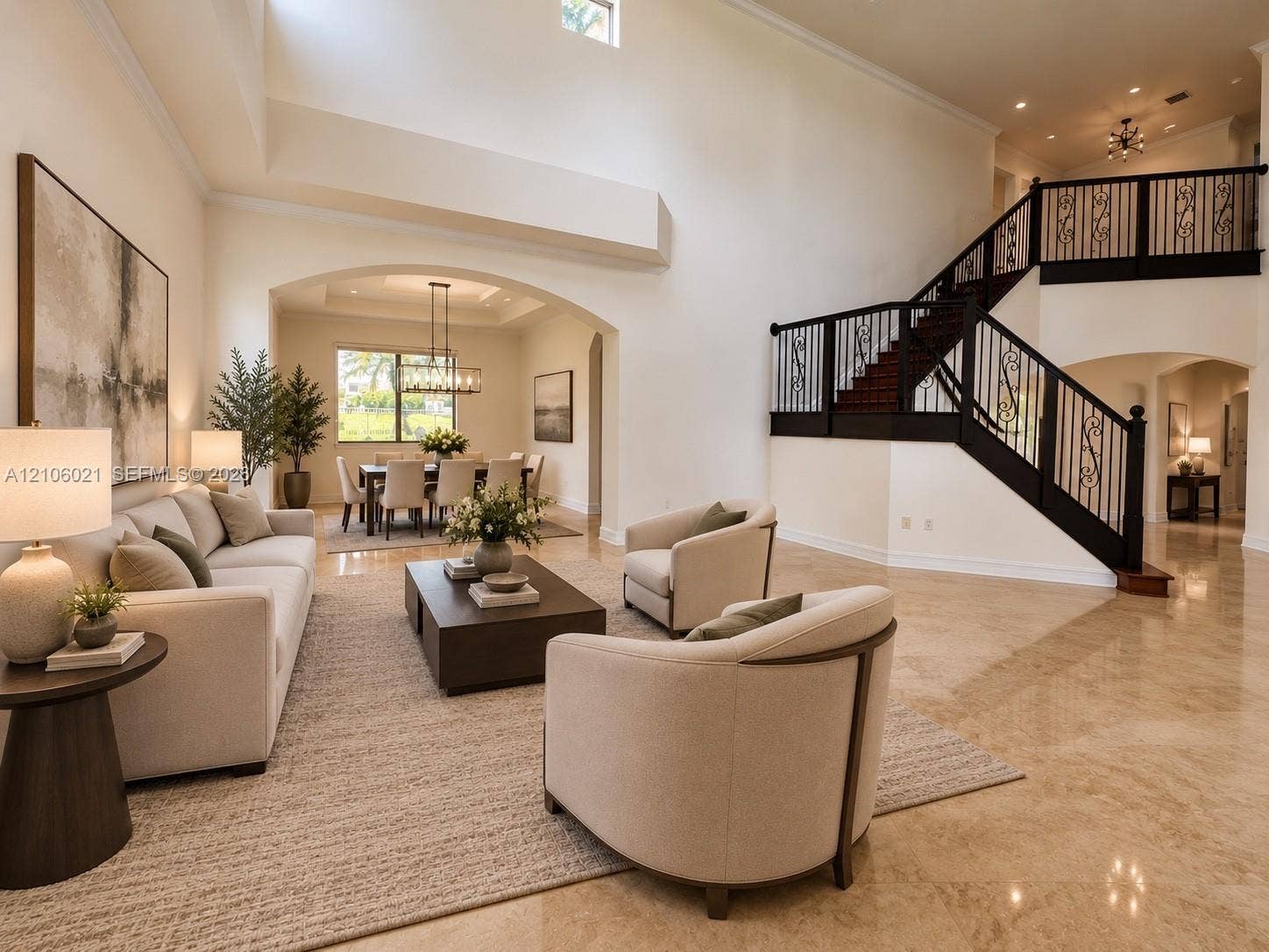 19510 S Coquina Way, Weston, FL 33332 Two-story vaulted ceiling, polished stone flooring, custom staircase with iron railings, arched architectural pass-throughs, and recessed lighting