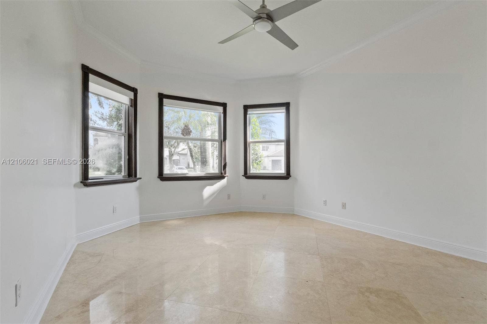19510 S Coquina Way, Weston, FL 33332 Bay window featuring dark-trimmed glass panes, large-format tile flooring, and a central ceiling fan