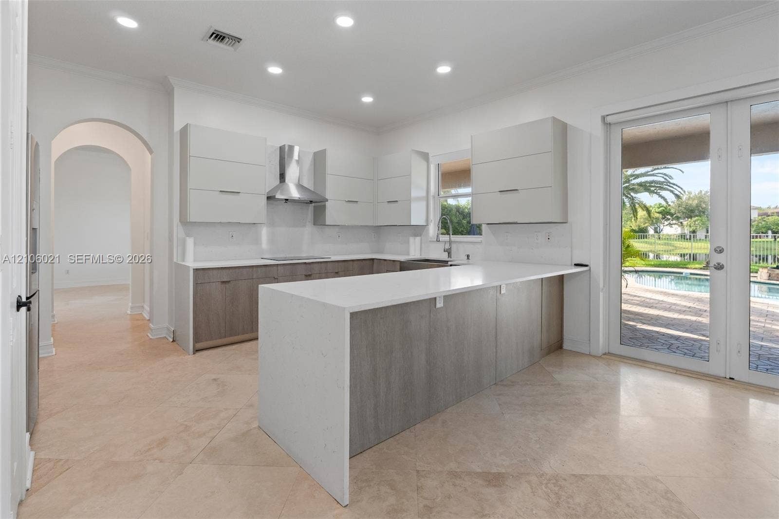 19510 S Coquina Way, Weston, FL 33332 Kitchen featuring two-tone flat-panel cabinetry, waterfall-edge stone countertops, recessed lighting, and stainless steel range hood