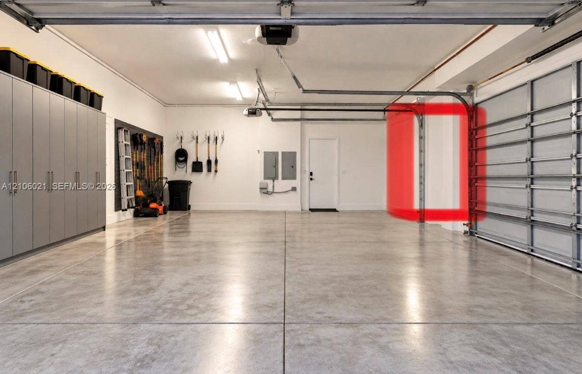 19510 S Coquina Way, Weston, FL 33332 Spacious multi-car garage featuring finished concrete flooring, extensive built-in cabinetry, and LED strip lighting