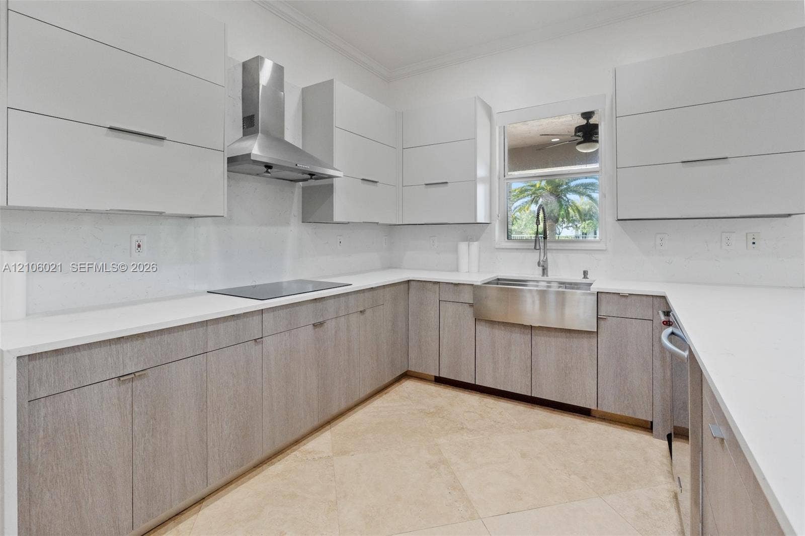 19510 S Coquina Way, Weston, FL 33332 Kitchen featuring two-tone flat-panel cabinetry, light-toned stone-finish countertops, stainless steel farmhouse sink with gooseneck faucet, stainless steel range hood, and tile flooring