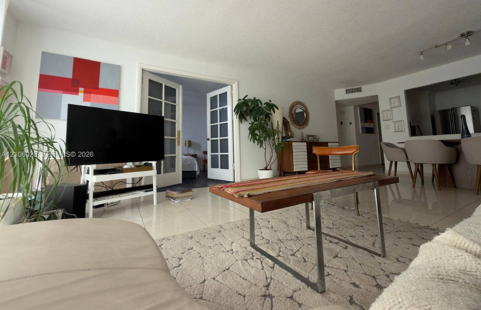 2780 NE 183rd Street, #1605, Aventura, FL 33160 Large-format tile flooring, white-finish walls, and glass-paneled double French doors