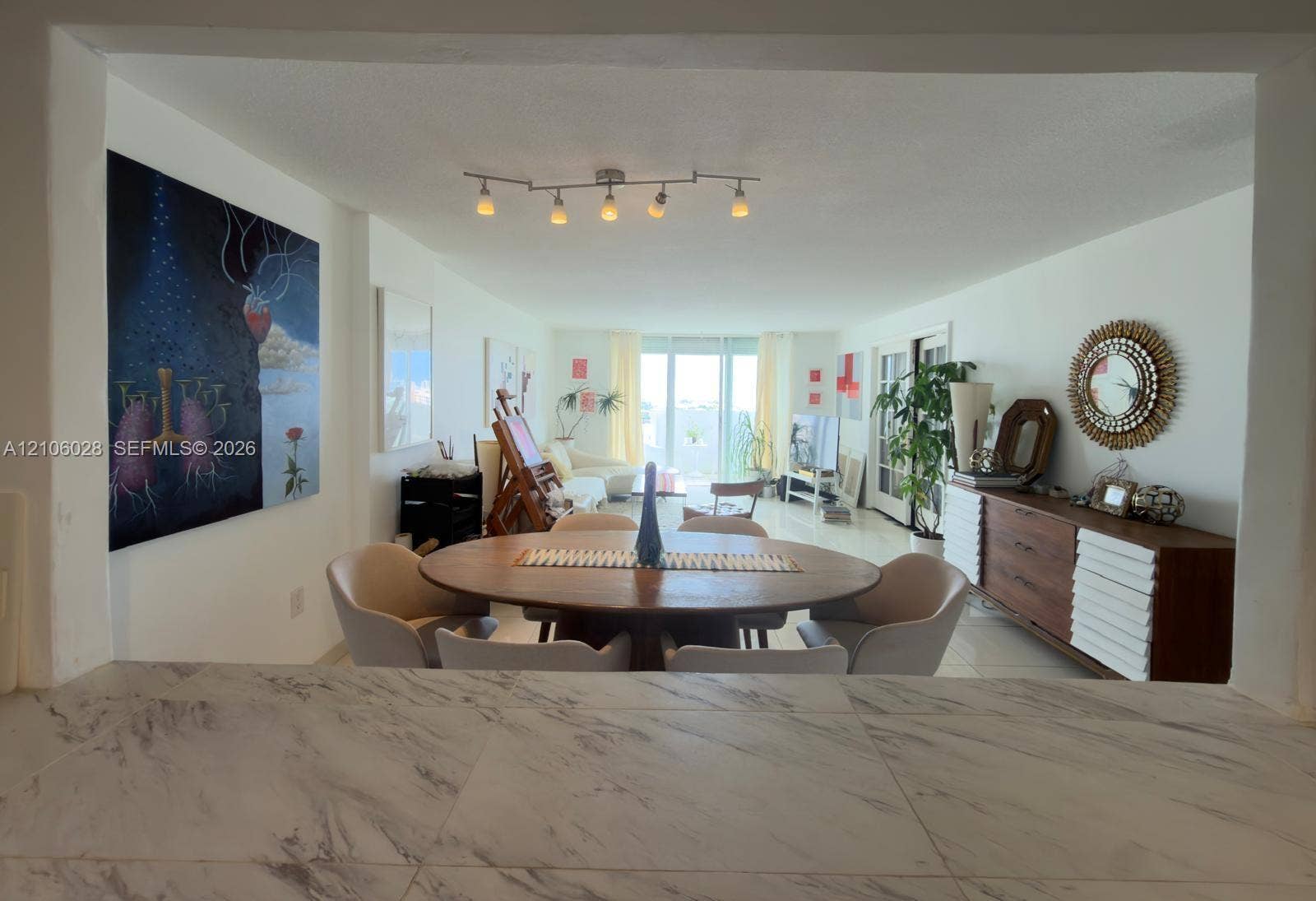 2780 NE 183rd Street, #1605, Aventura, FL 33160 Countertop with a neutral stone-pattern finish, overhead adjustable track lighting, and smooth-finish flooring