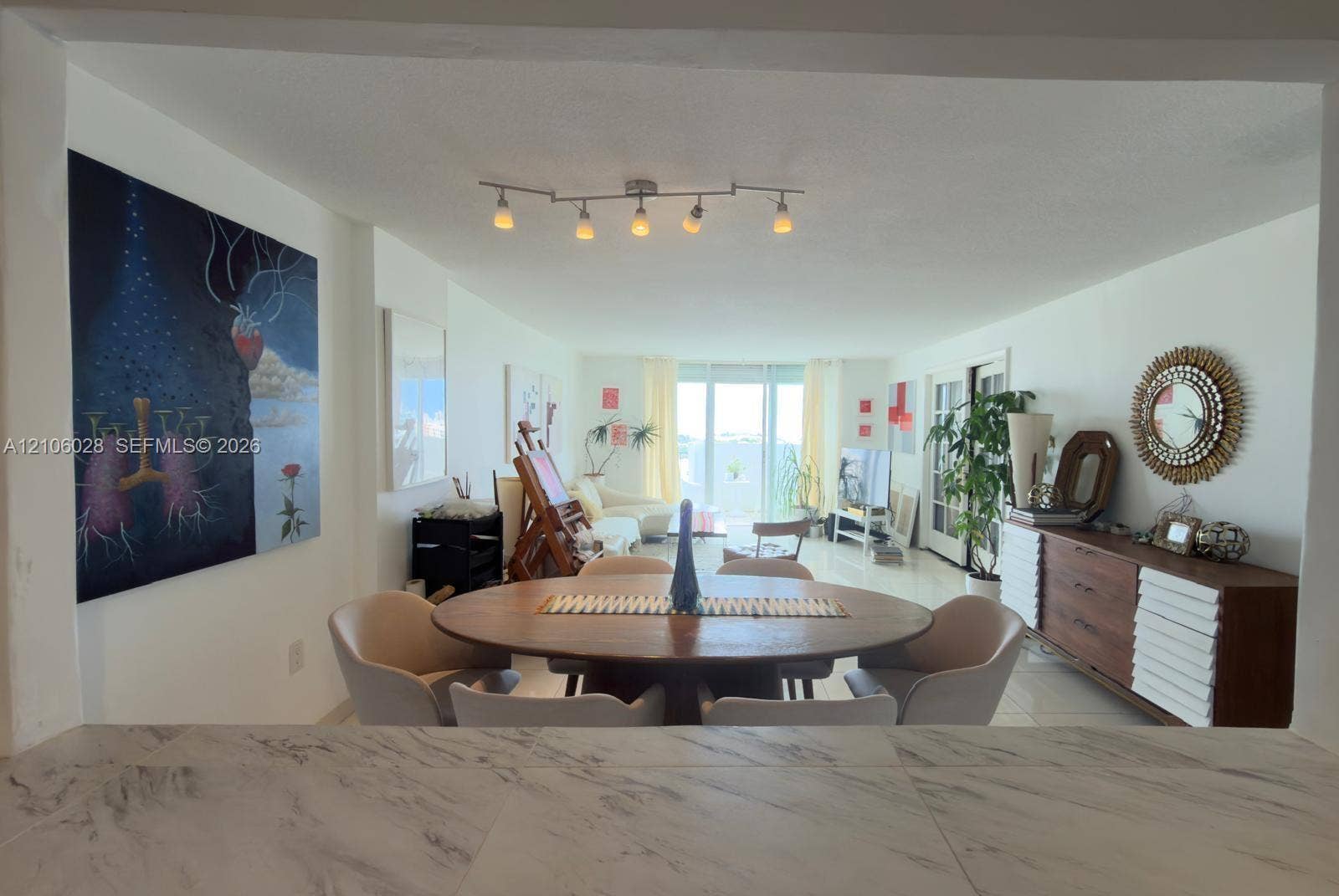 2780 NE 183rd Street, #1605, Aventura, FL 33160 Open-concept area featuring stone-finish countertop, polished tile flooring, and multi-directional track lighting