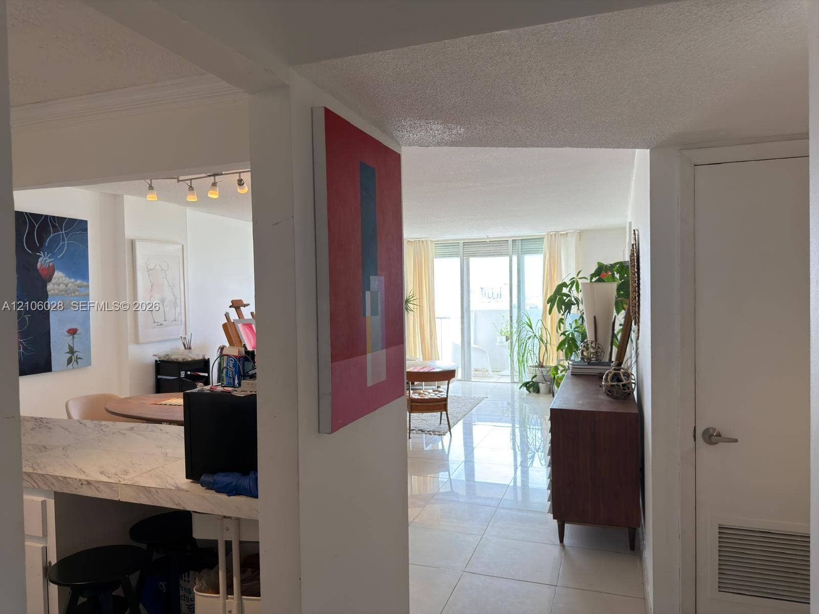2780 NE 183rd Street, #1605, Aventura, FL 33160 Polished stone flooring, counter with integrated stone-finish surface, and floor-to-ceiling glass sliding doors