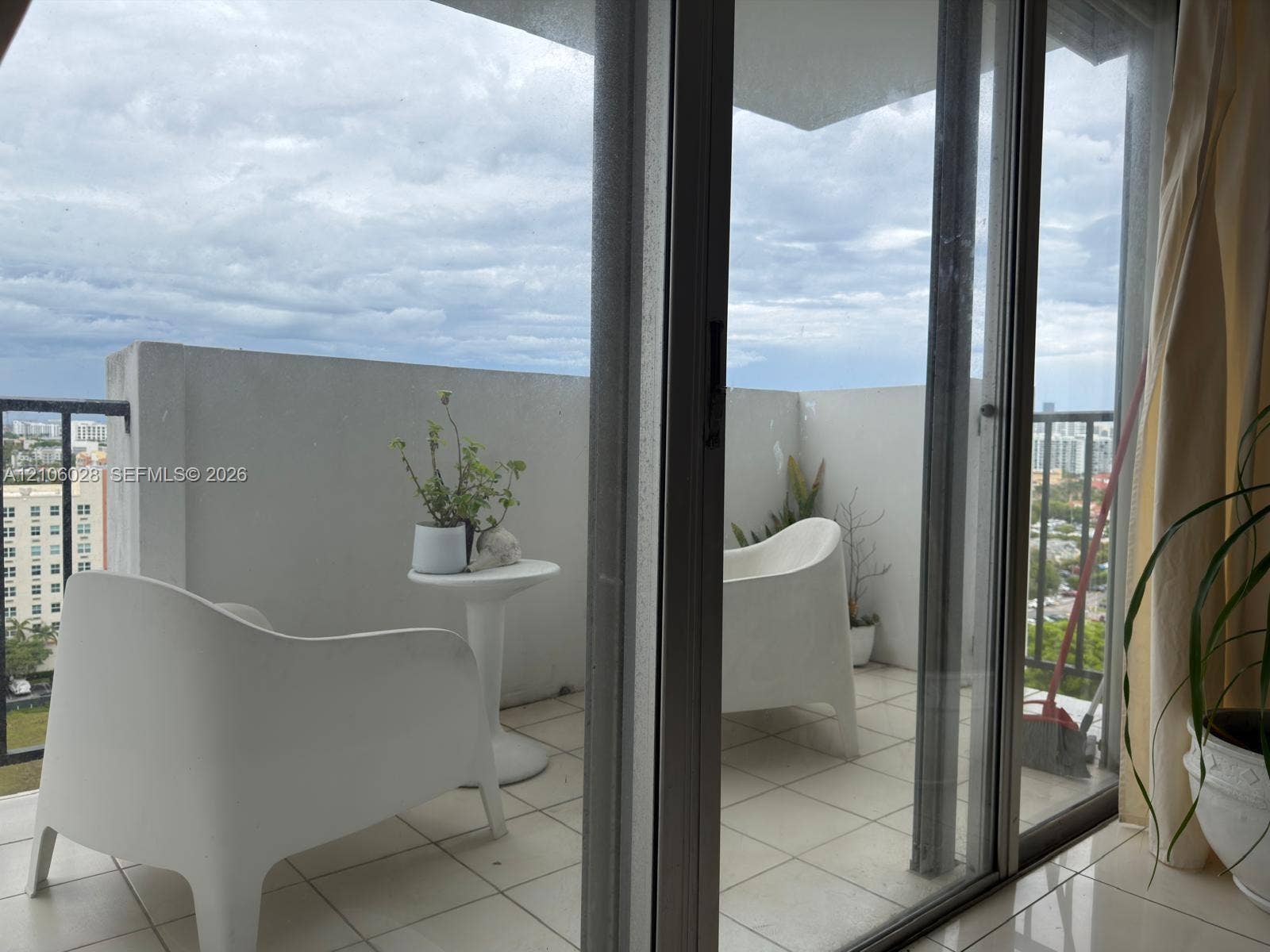 2780 NE 183rd Street, #1605, Aventura, FL 33160 Private balcony featuring ceramic tile flooring, solid concrete perimeter walls, and sliding glass entry doors