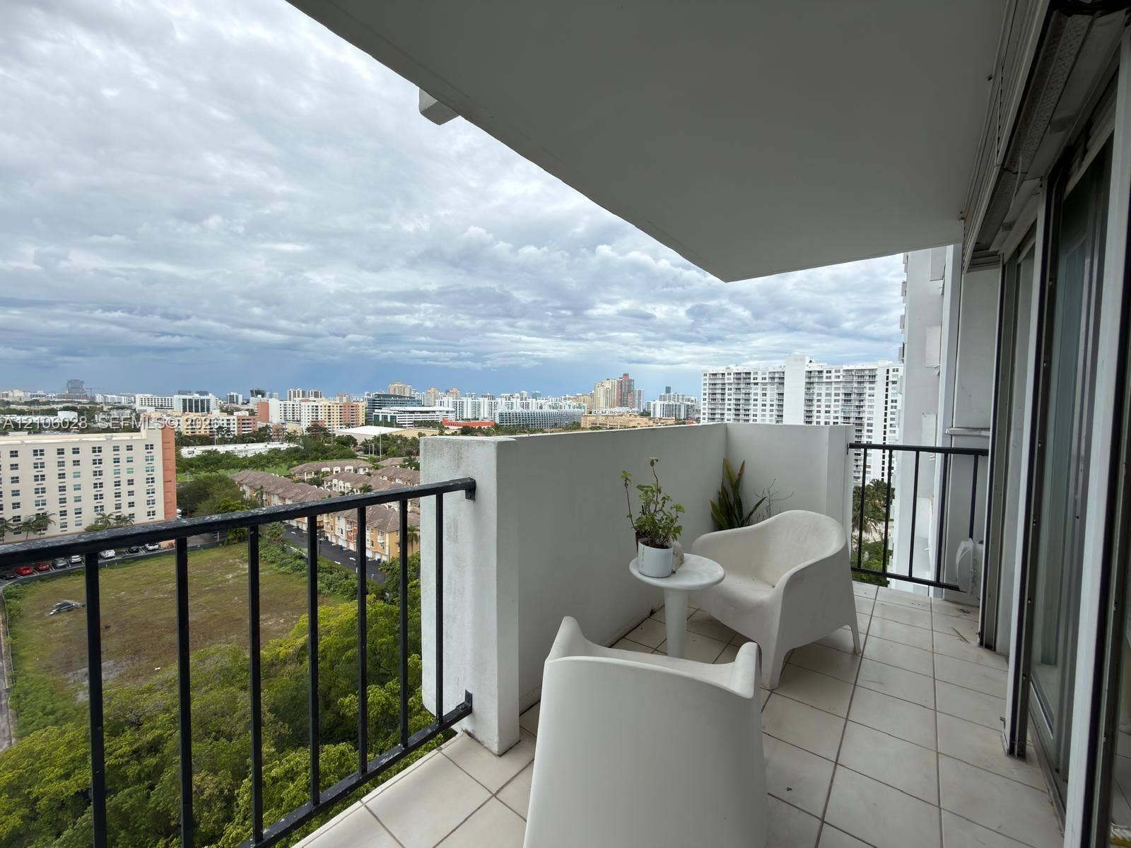 2780 NE 183rd Street, #1605, Aventura, FL 33160 Covered balcony featuring white tiled flooring and black metal railing