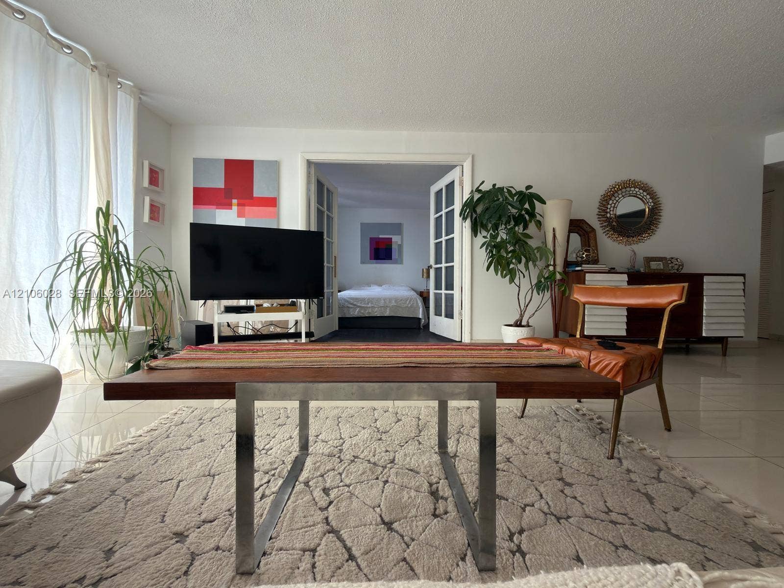 2780 NE 183rd Street, #1605, Aventura, FL 33160 Open living space featuring tile flooring, neutral wall tones, and floor-to-ceiling window coverings