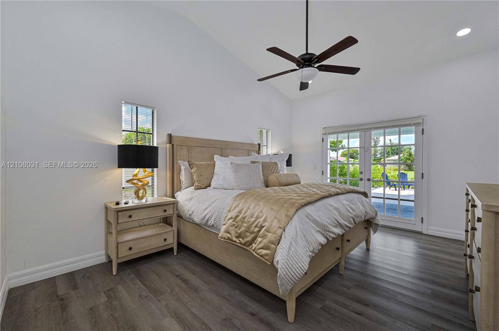 1106 SE 23rd Place, Cape Coral, FL 33990 Vaulted ceilings, wood-finish flooring, recessed lighting, ceiling fan, and glass-paneled double doors
