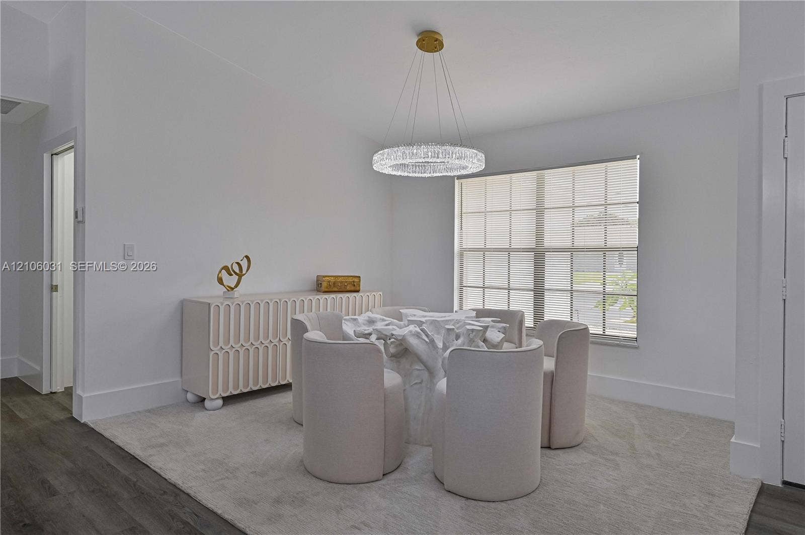 1106 SE 23rd Place, Cape Coral, FL 33990 Circular crystal chandelier, multi-pane window, and wood-finish flooring