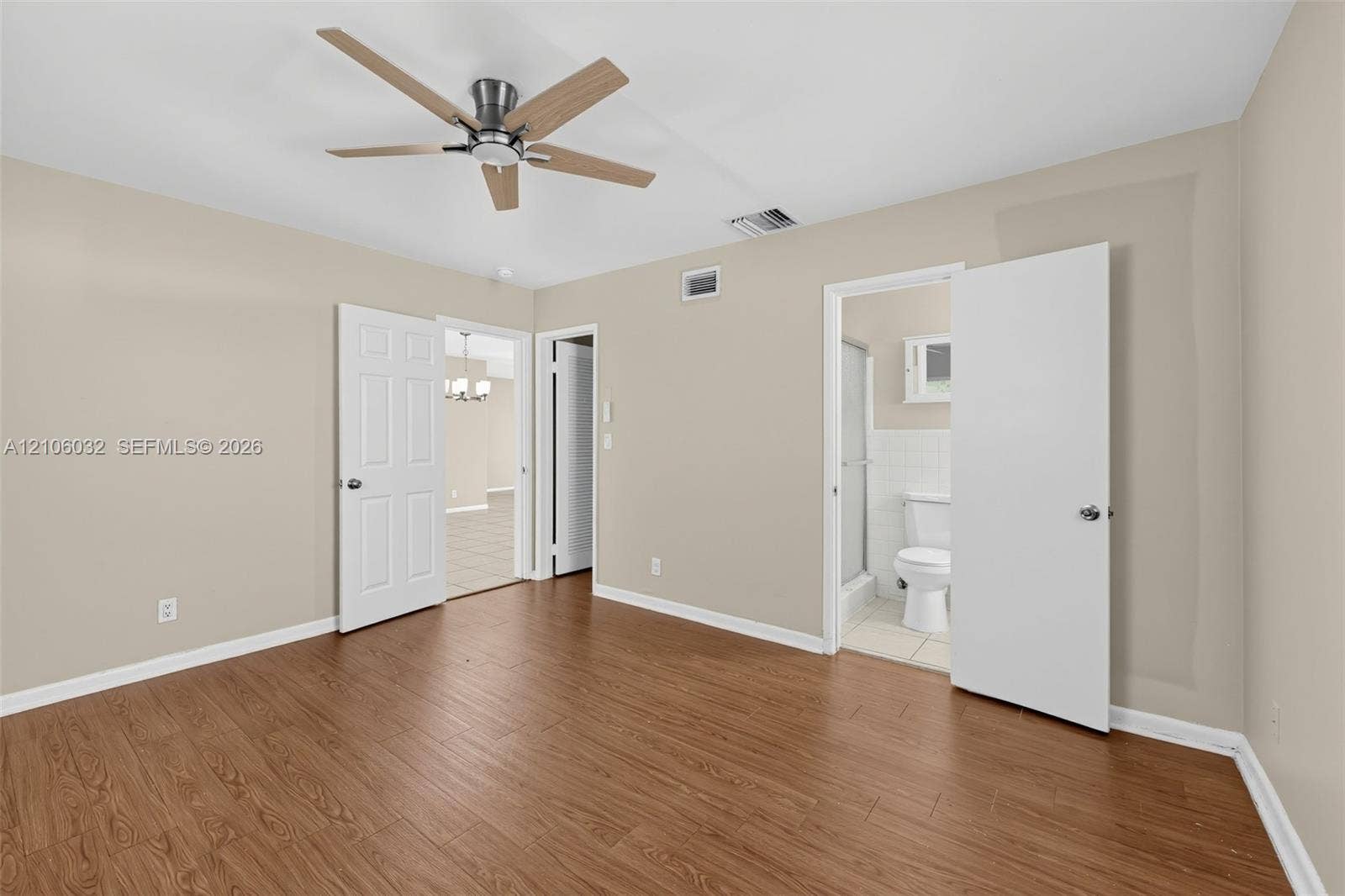 759 NW 7th Street, Boca Raton, FL 33486 Room featuring wood-finish flooring, a multi-blade ceiling fan with integrated lighting, and neutral wall tones