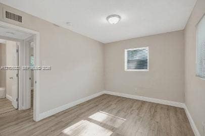 1471 NW 22nd Court, #2, Fort Lauderdale, Fort Lauderdale, FL 33311 Neutral-toned interior featuring wood-finish flooring, crisp white trim, and a flush-mount ceiling light fixture