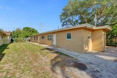 1471 NW 22nd Court, #2, Fort Lauderdale, Fort Lauderdale, FL 33311 Single-story structure featuring a stucco exterior, concrete path, and gravel ground cover