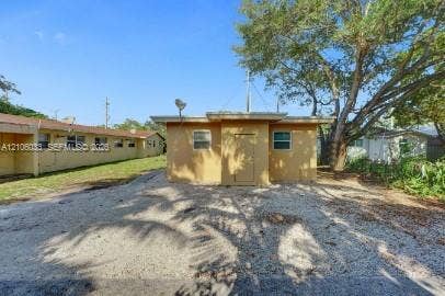 1471 NW 22nd Court, #2, Fort Lauderdale, Fort Lauderdale, FL 33311 Single-story exterior featuring stucco siding, a flat roofline, and gravel surfacing