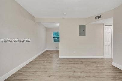 1471 NW 22nd Court, #2, Fort Lauderdale, Fort Lauderdale, FL 33311 Neutral-toned interior featuring wood-finish flooring, a six-panel door, and a single-pane window