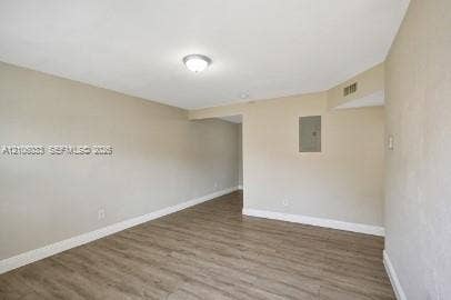 1471 NW 22nd Court, #2, Fort Lauderdale, Fort Lauderdale, FL 33311 Interior space featuring neutral wall paint, wood-finish flooring, and a flush-mount ceiling light fixture