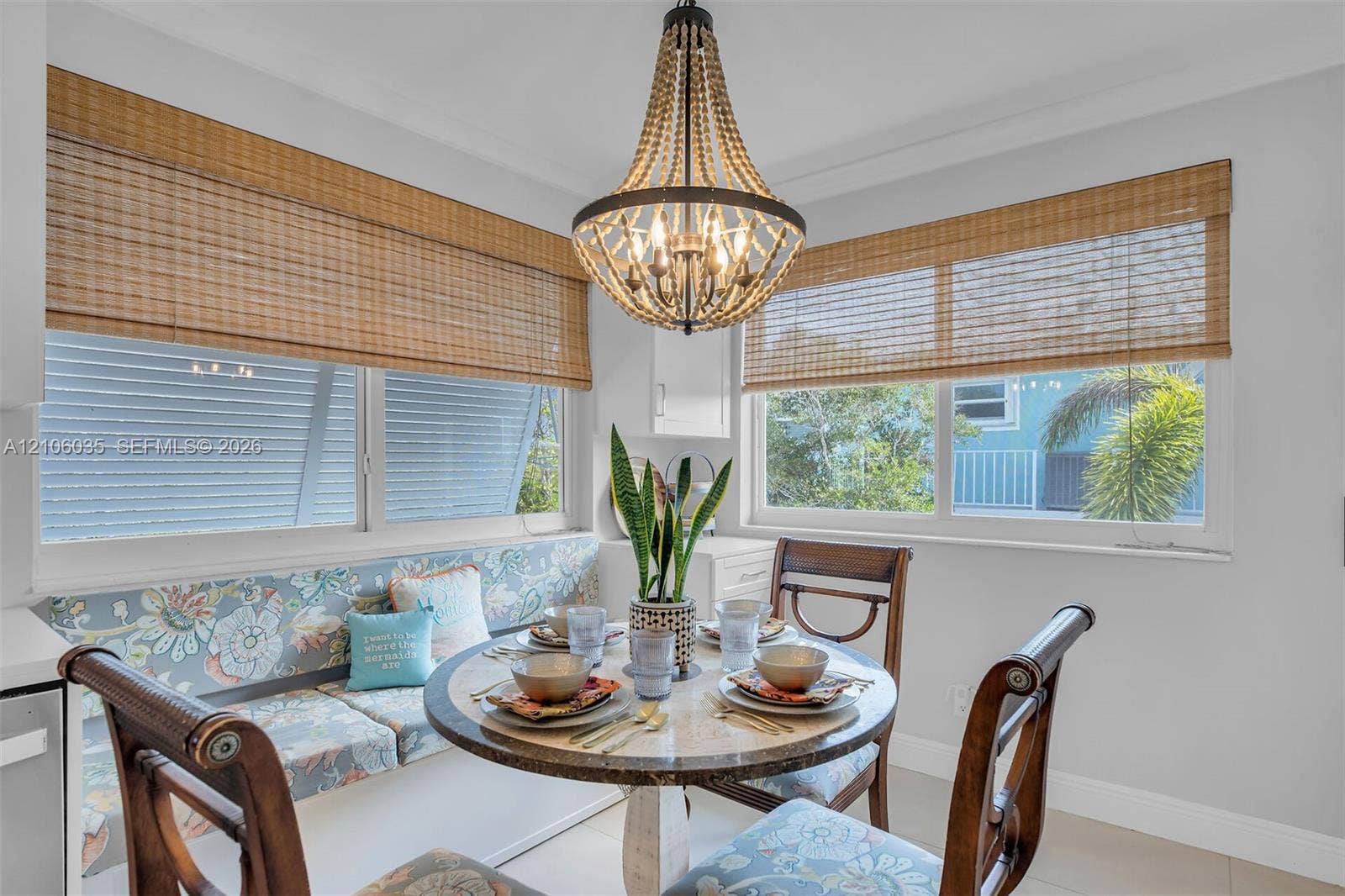 128 Dove Avenue, Tavernier, FL 33070 Beaded empire chandelier, custom built-in window seating, and woven wood window shades