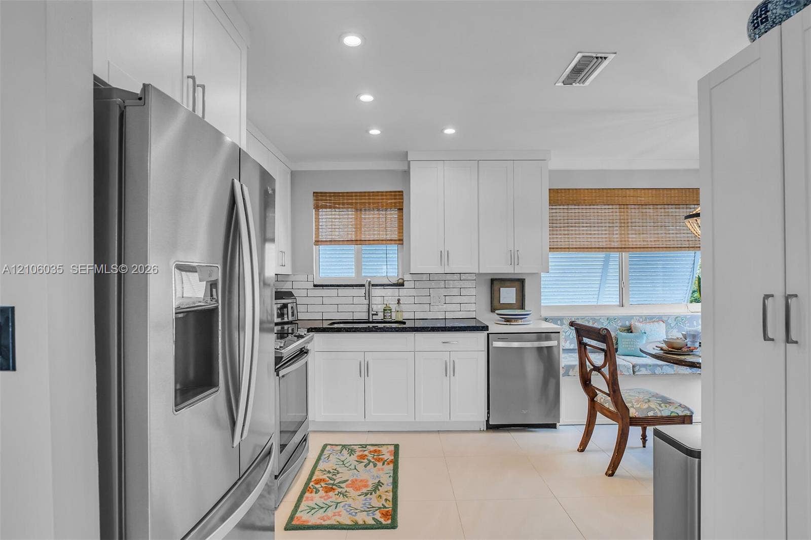 128 Dove Avenue, Tavernier, FL 33070 Kitchen featuring white cabinetry, subway tile backsplash, dark solid-surface countertops, recessed lighting, and stainless steel appliances